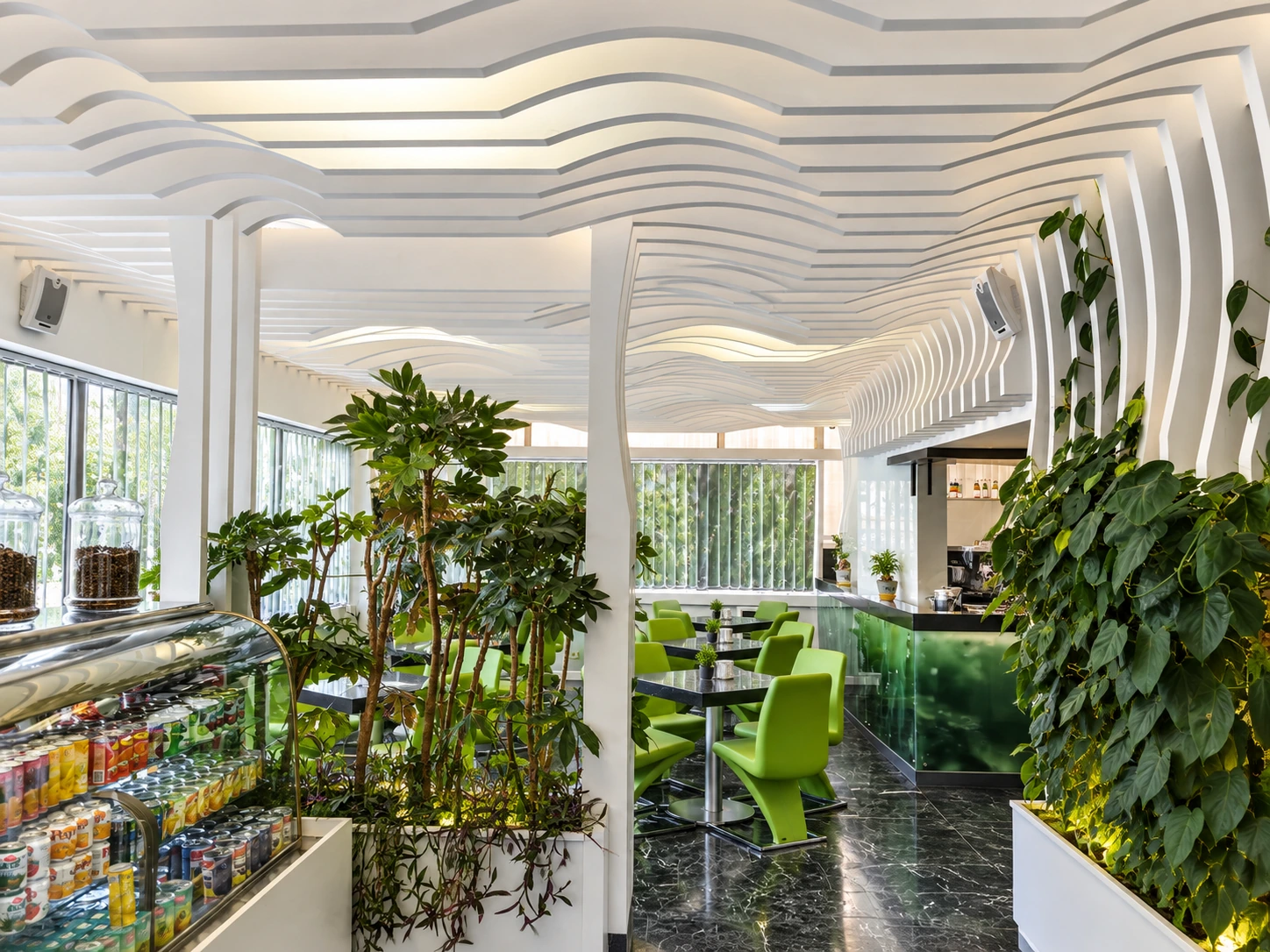 Biophilic lounge area at Atiyeh Hospital Café with lush planters and custom white ceiling design
