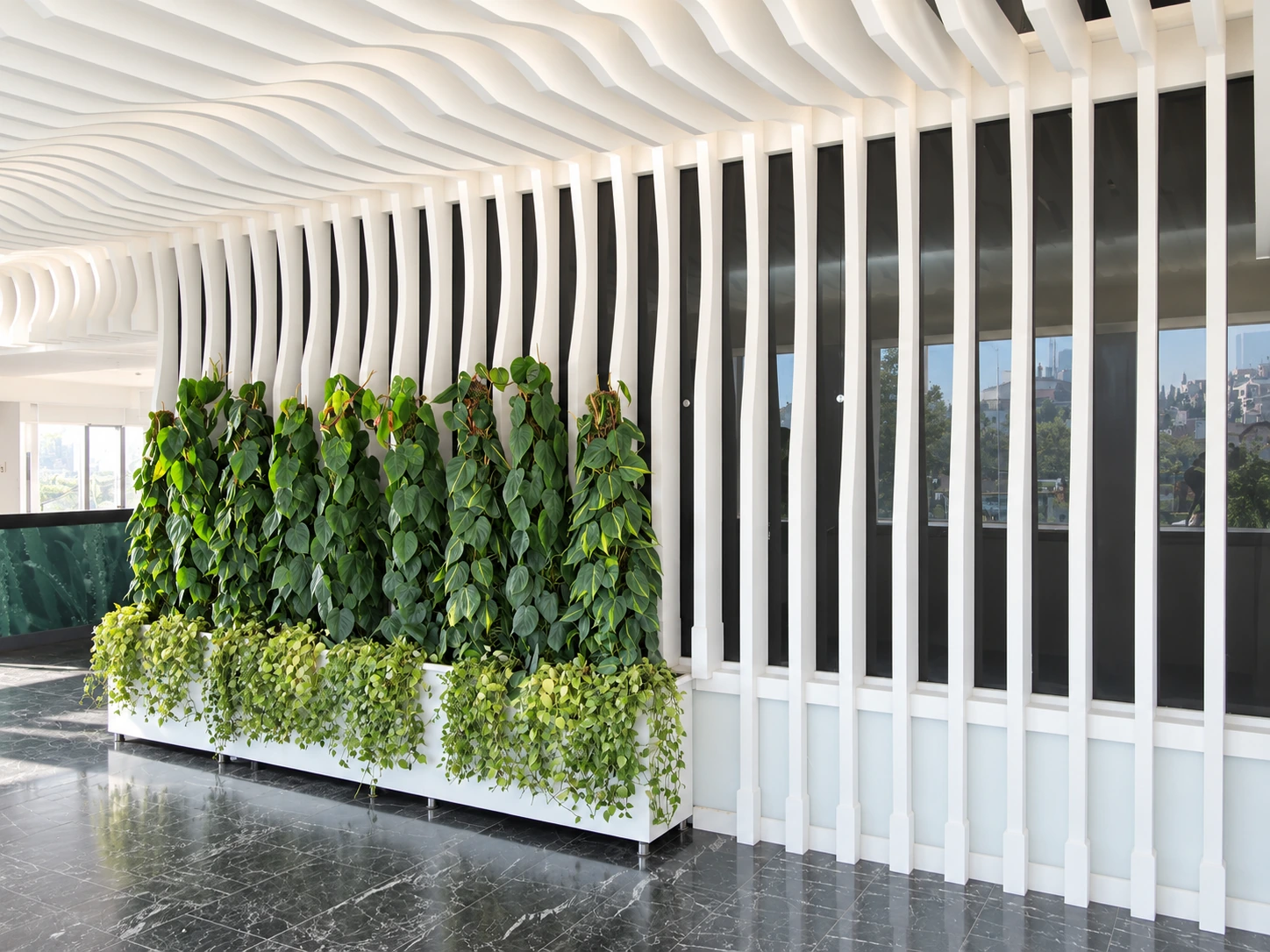 Green partition wall and sculptural interior elements in Atiyeh Hospital Café