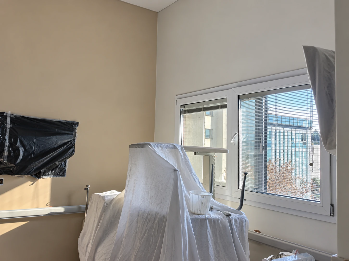 Construction-stage view of the Dey Hospital VIP ward near the window and protected equipment