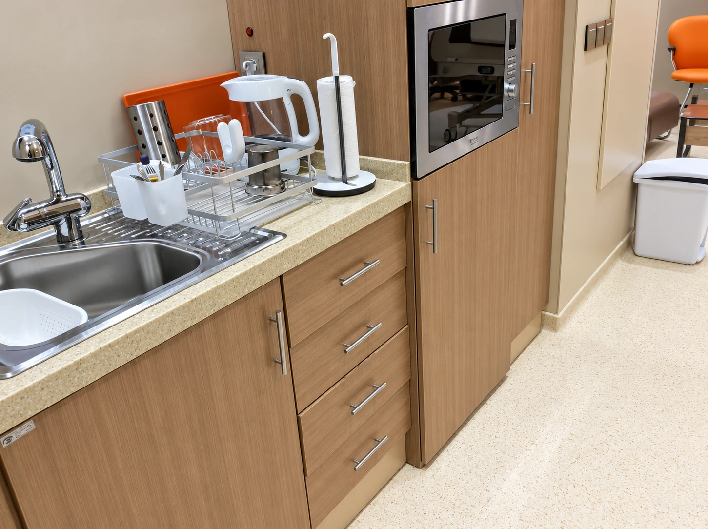 Integrated kitchenette in the Dey Hospital VIP room with sink, cabinetry and guest amenities