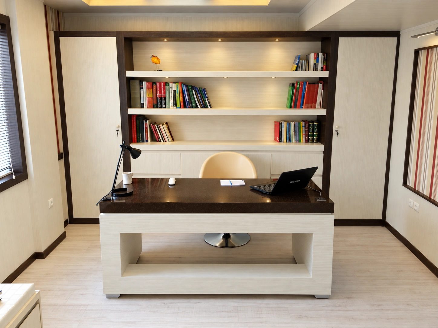 Consultation office at Dr. Fathi Cardiology Clinic with custom desk, storage and warm interior finishes