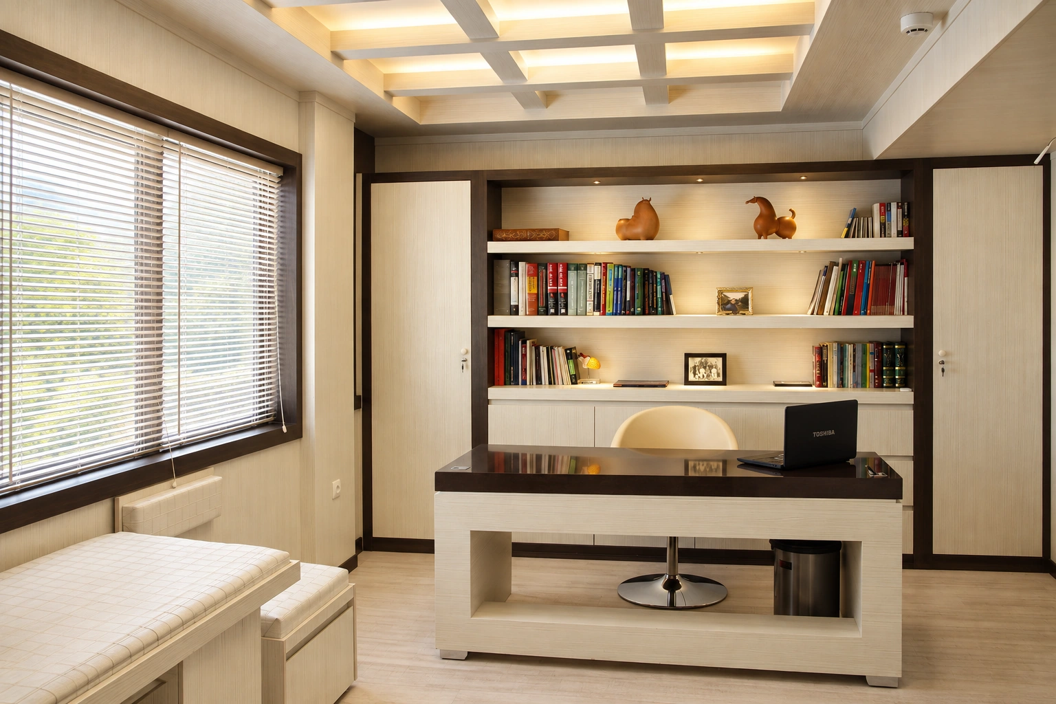 Main office at Dr. Fathi Cardiology Clinic with custom desk, built-in library and integrated ceiling lighting