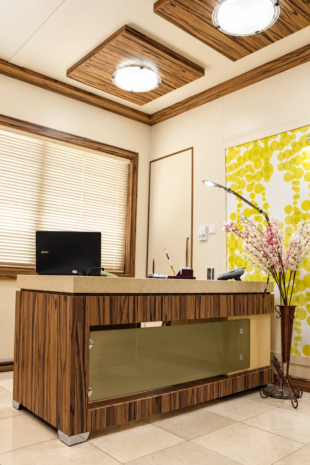 Reception area of Dr. Fathi Cardiology Clinic with custom wood desk and decorative feature wall