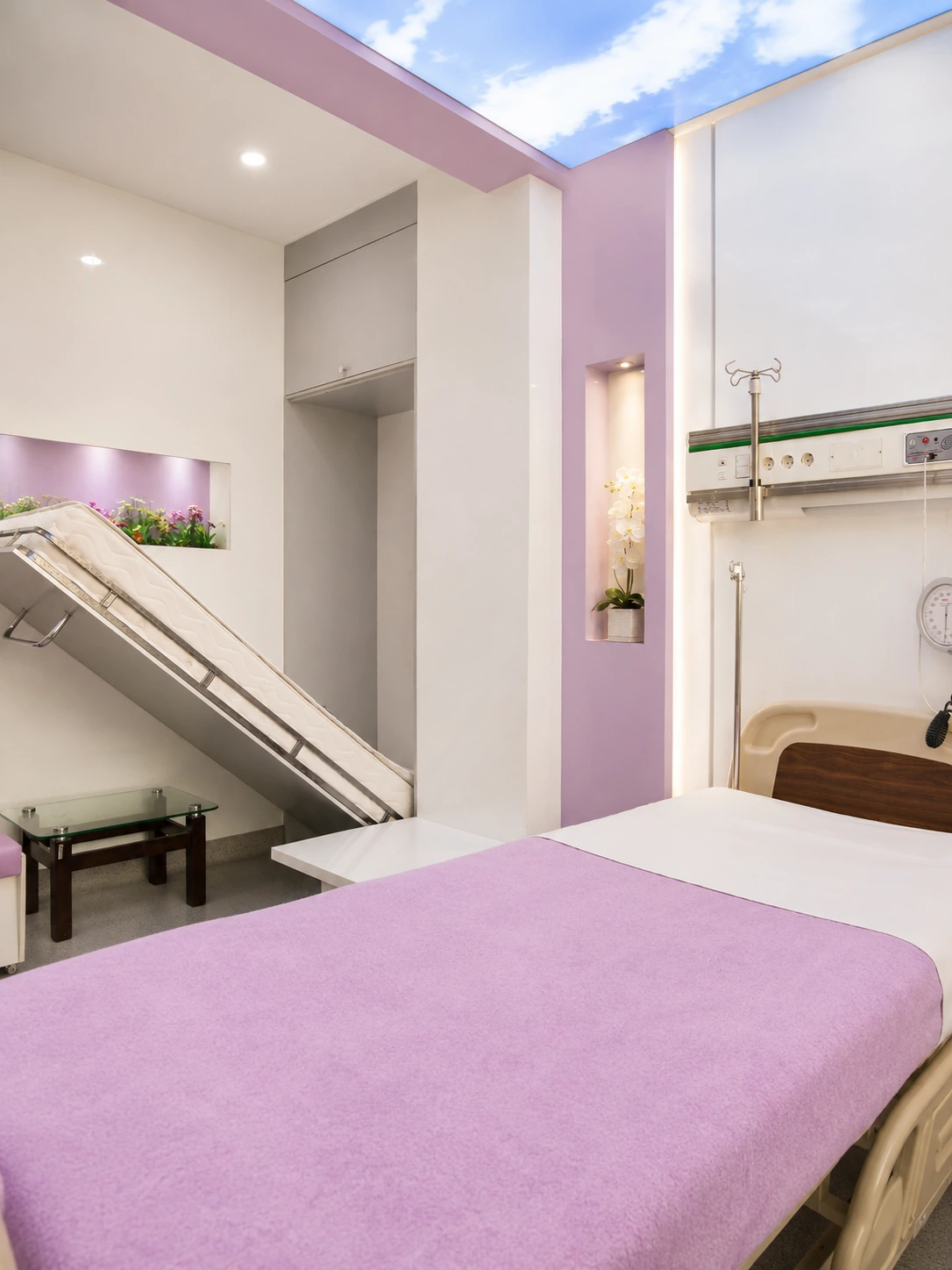 VIP patient bed detail at Day Hospital with lavender interior, medical headwall and decorative illuminated niches