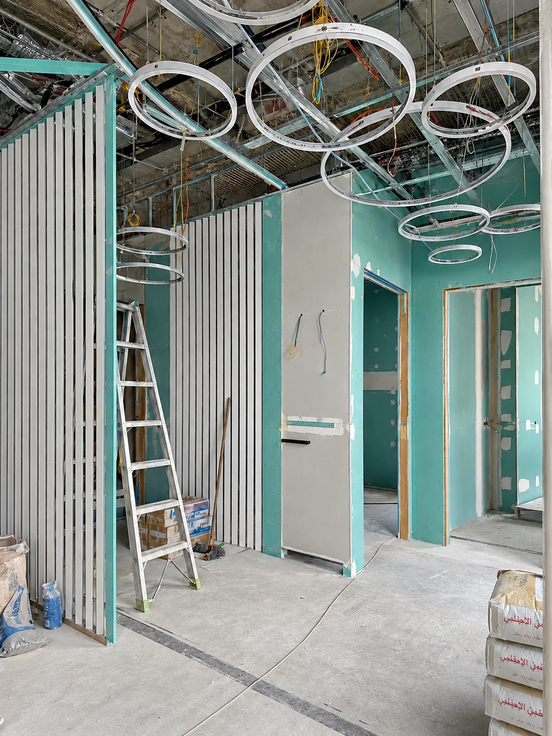 Construction phase showing ceiling framing and circular light supports at Dr. Rashidinejad Laboratory