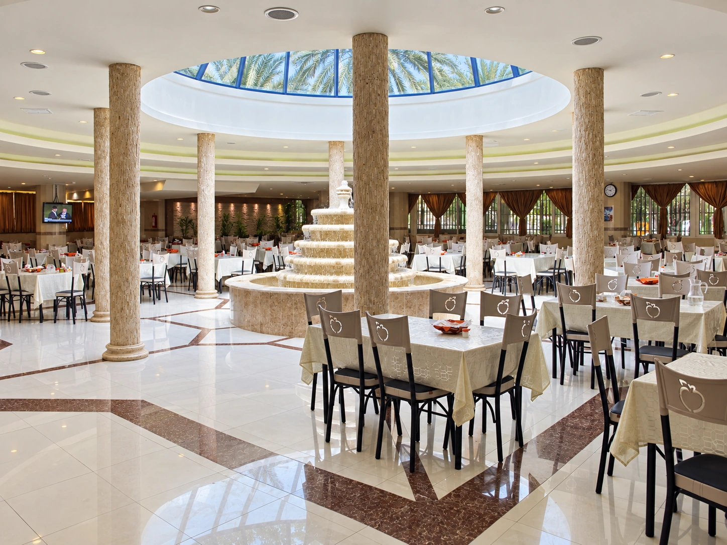 Symmetrical view of the renovated Shahid Rajaee Heart Center staff restaurant centered on the fountain and glazed dome