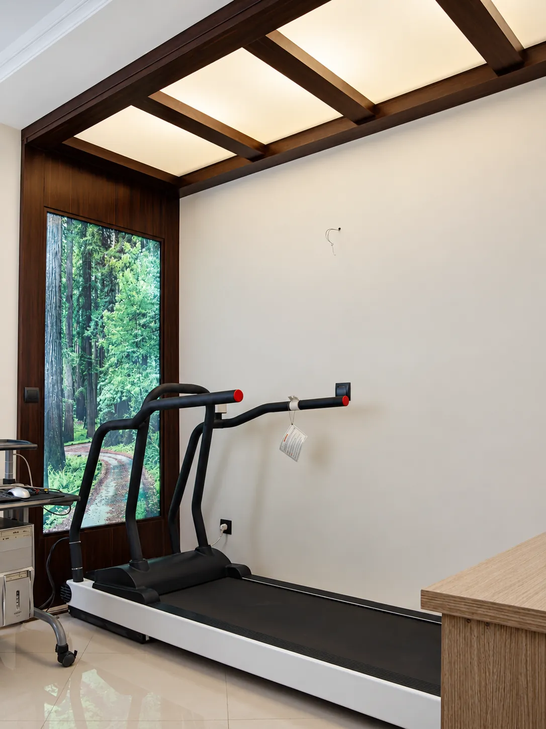 Interior fitness room at Jam Building with treadmill and dark wood ceiling frame
