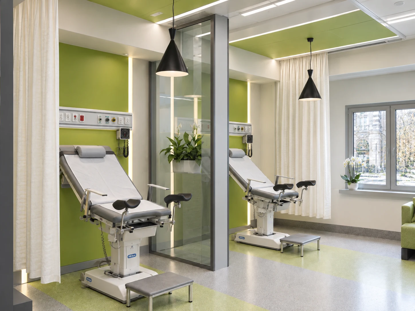 Overall view of the midwifery and examination room at Tehran Pars Hospital with exam chairs, glass divider and light green accents